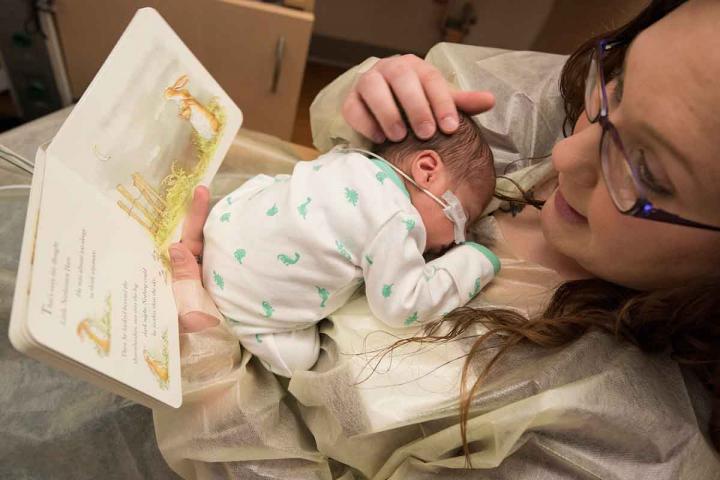 mum reading to premature baby